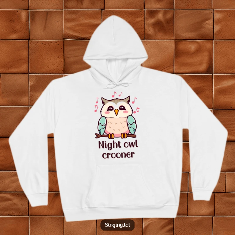 Funny hoodie depicting a cheerful owl with musical notes flowing from its beak, offering warmth and a dose of melodic humor.
