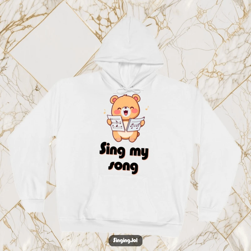 Funny hoodie with a happy bear character harmonizing from sheet music, offering warmth and musical joy.